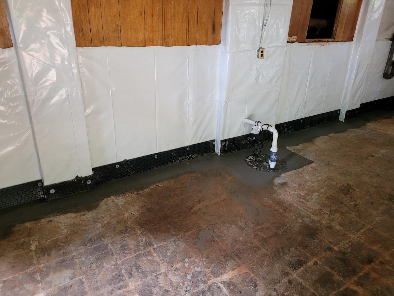 Finished Basement Medic waterproofing project showing a dry, clean basement after interior drain, sump, and dehumidification solution installation