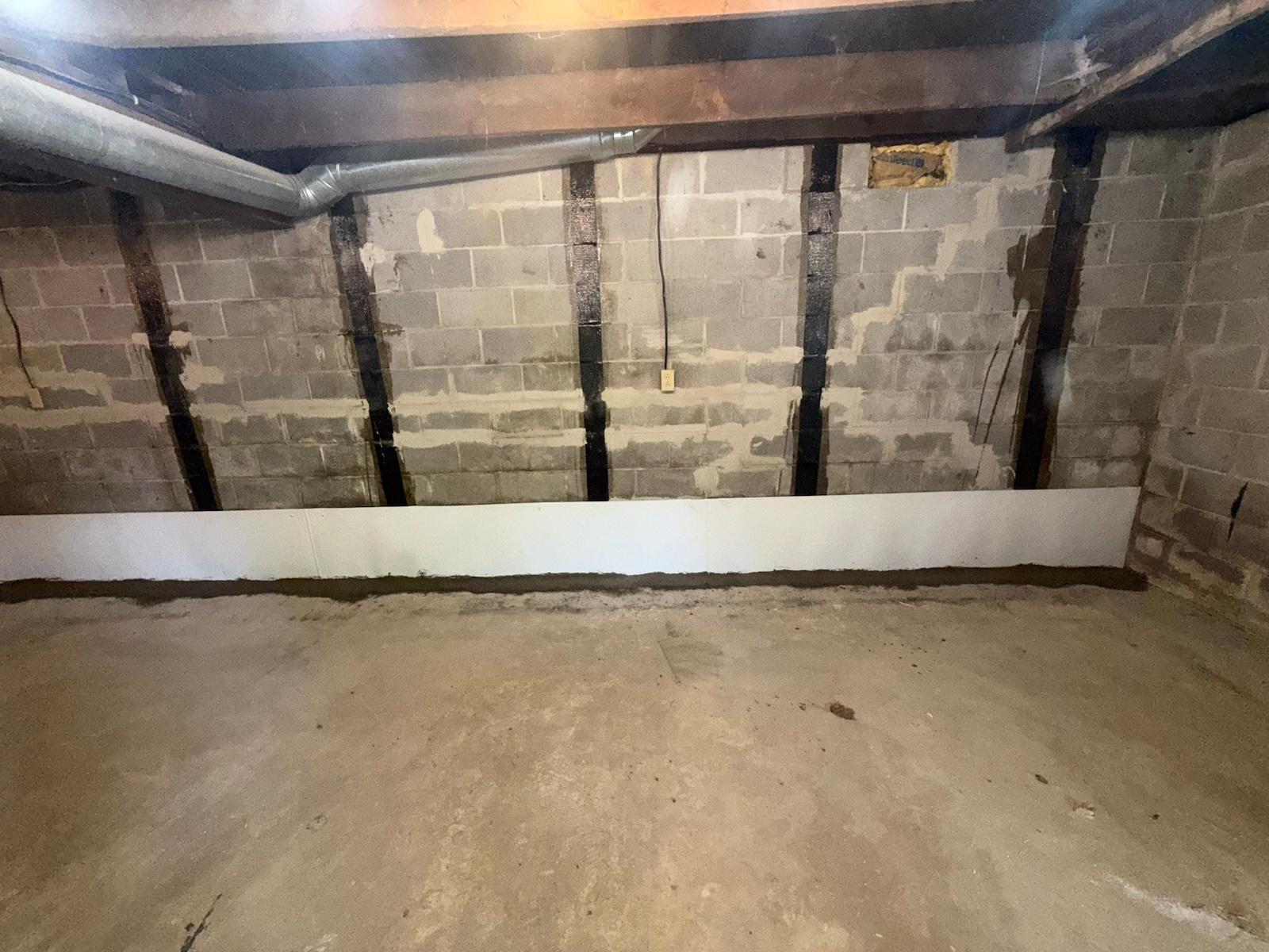 Carbon-fiber straps bonded vertically to a prepped basement block wall to stop further inward movement